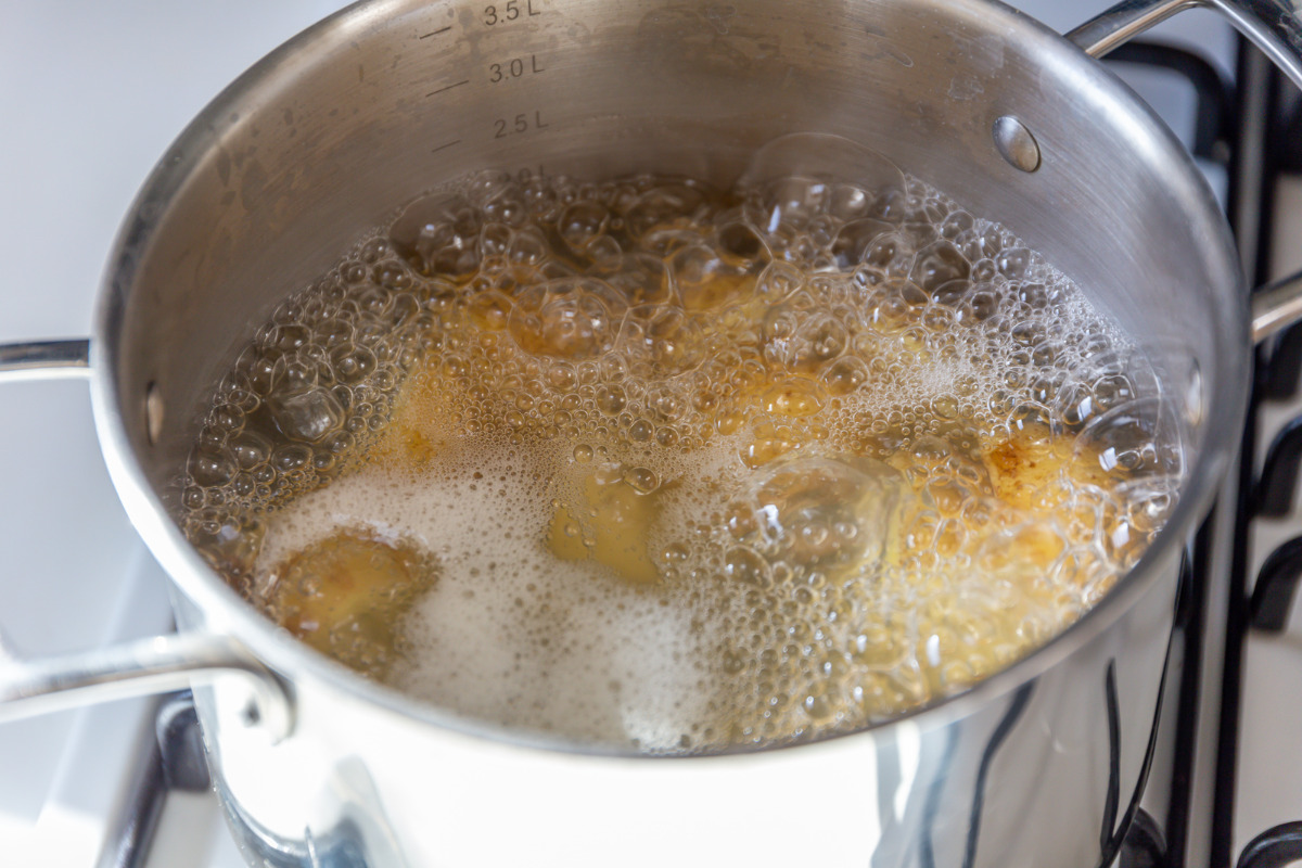 Potatoes simmering in a pot for potato soup.