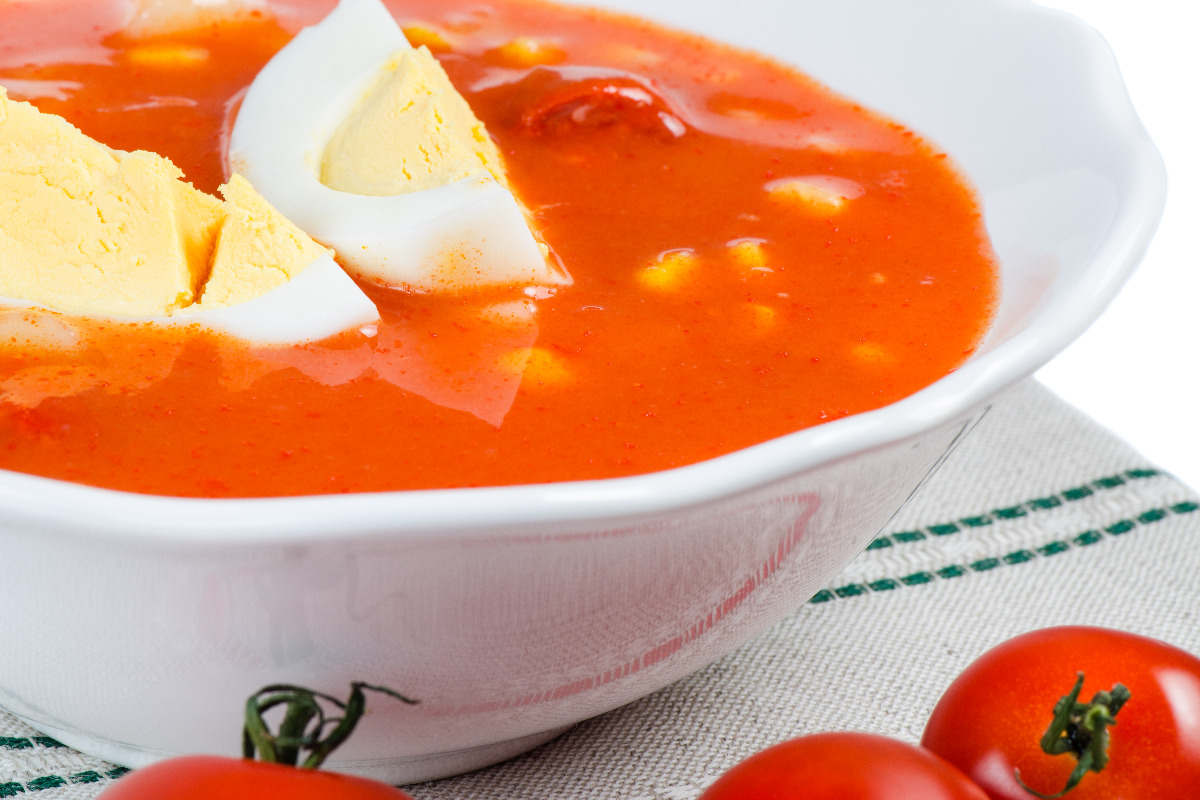 A bowl of tasty tomato soup with egg.