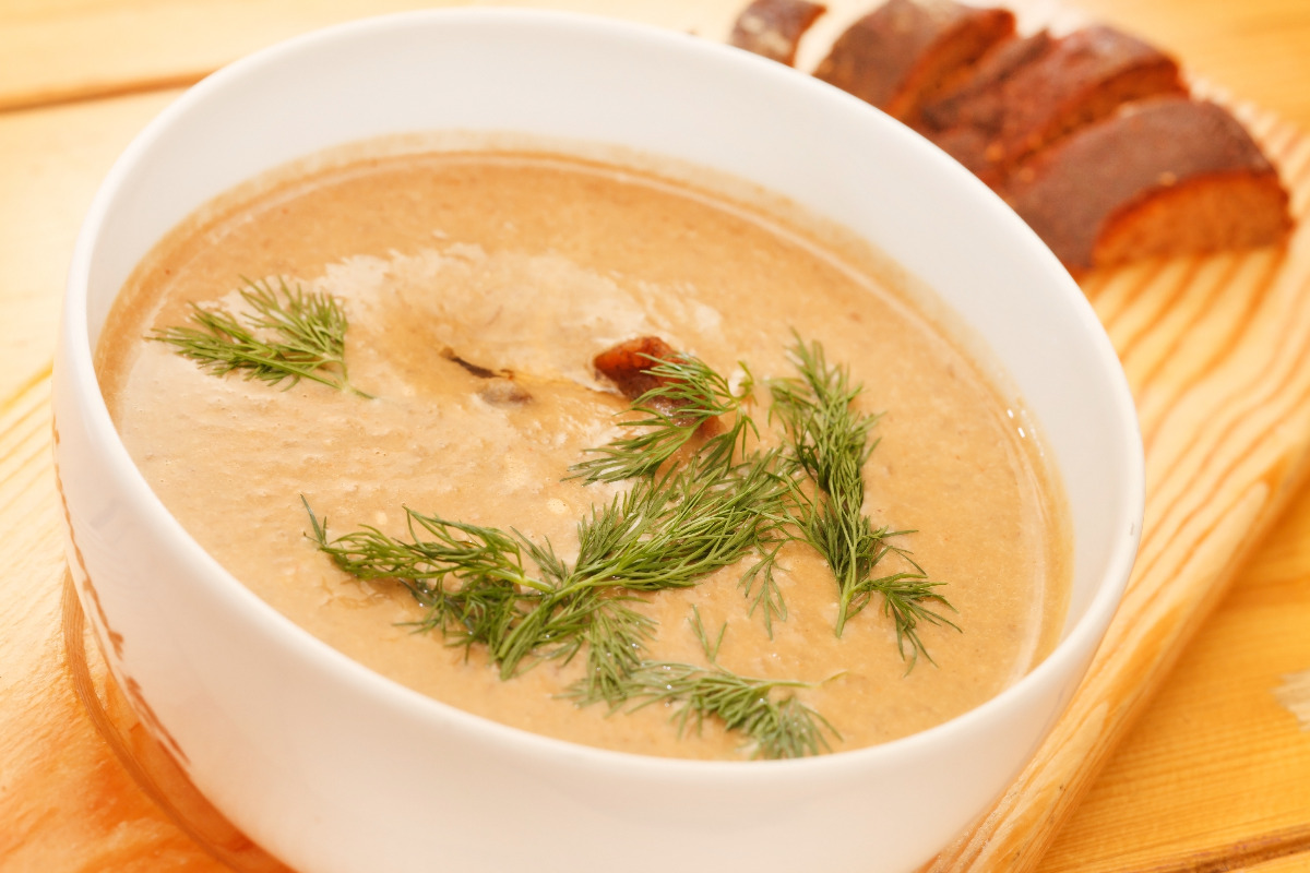 A delicious bow of creamy soup garnished with thyme.