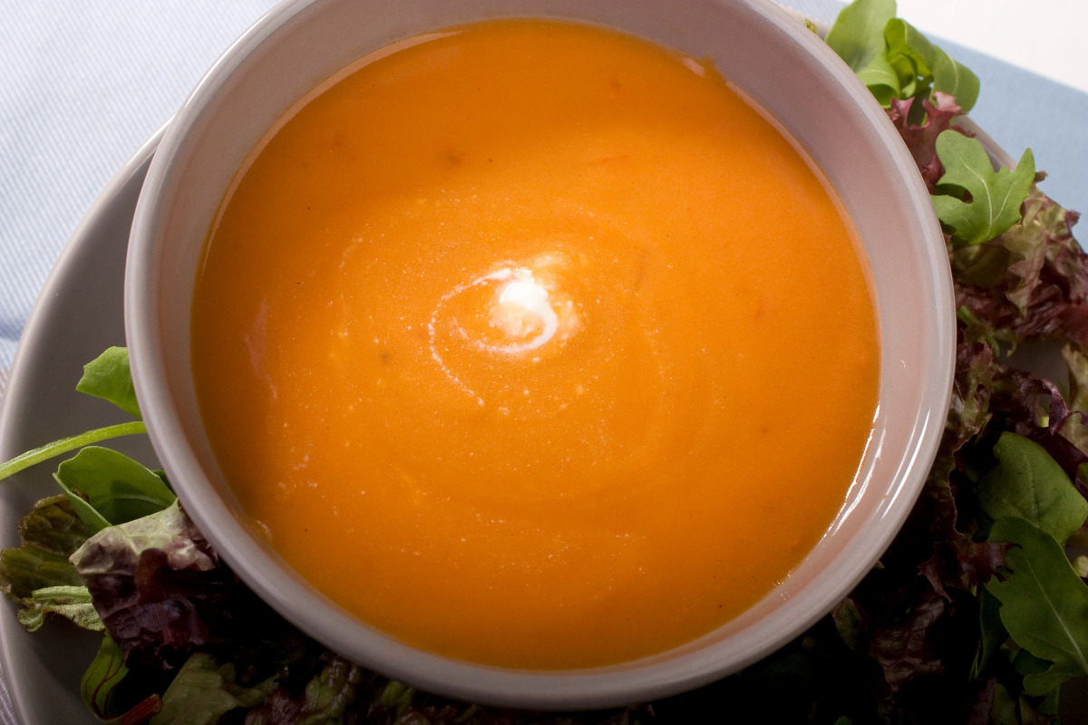 A bowl of delicious tomato soup mixed with cream.