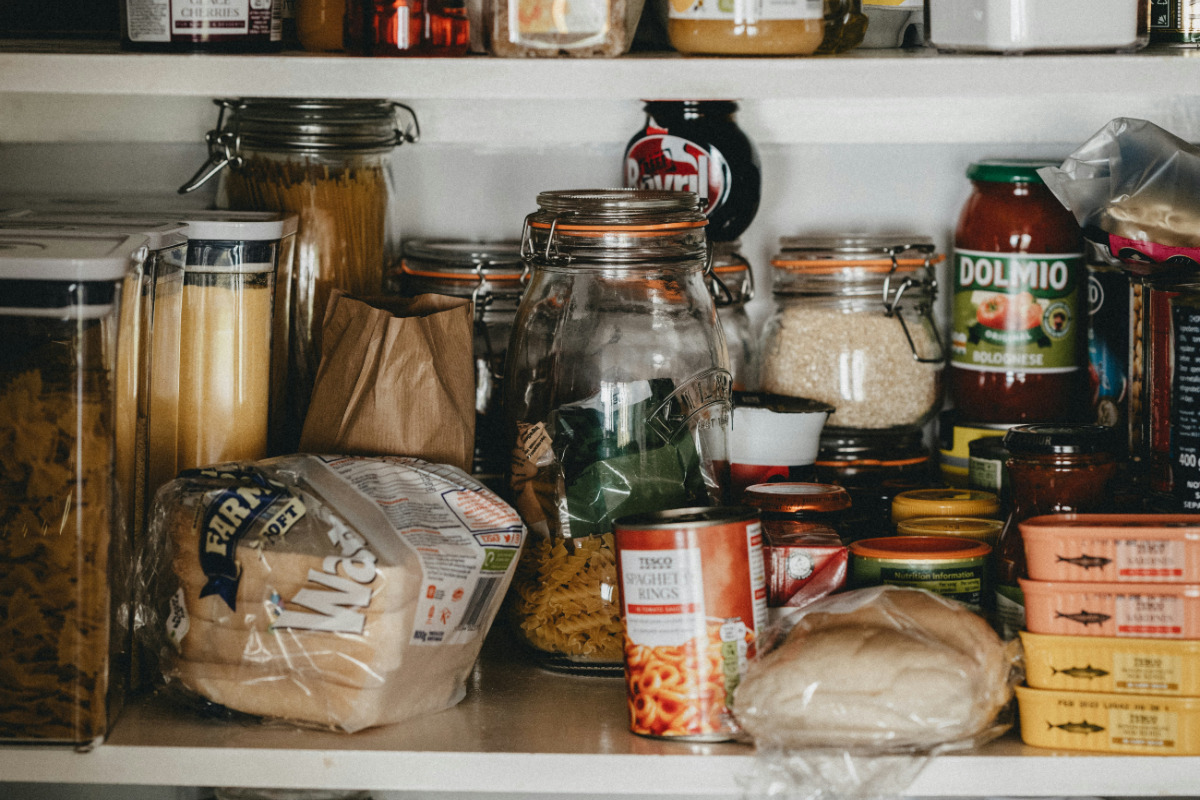 Various food items in a food pantry cabinet.