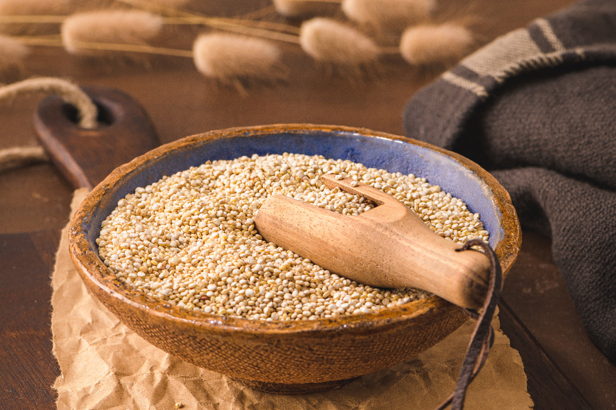 A wooden bowl of quinoa.